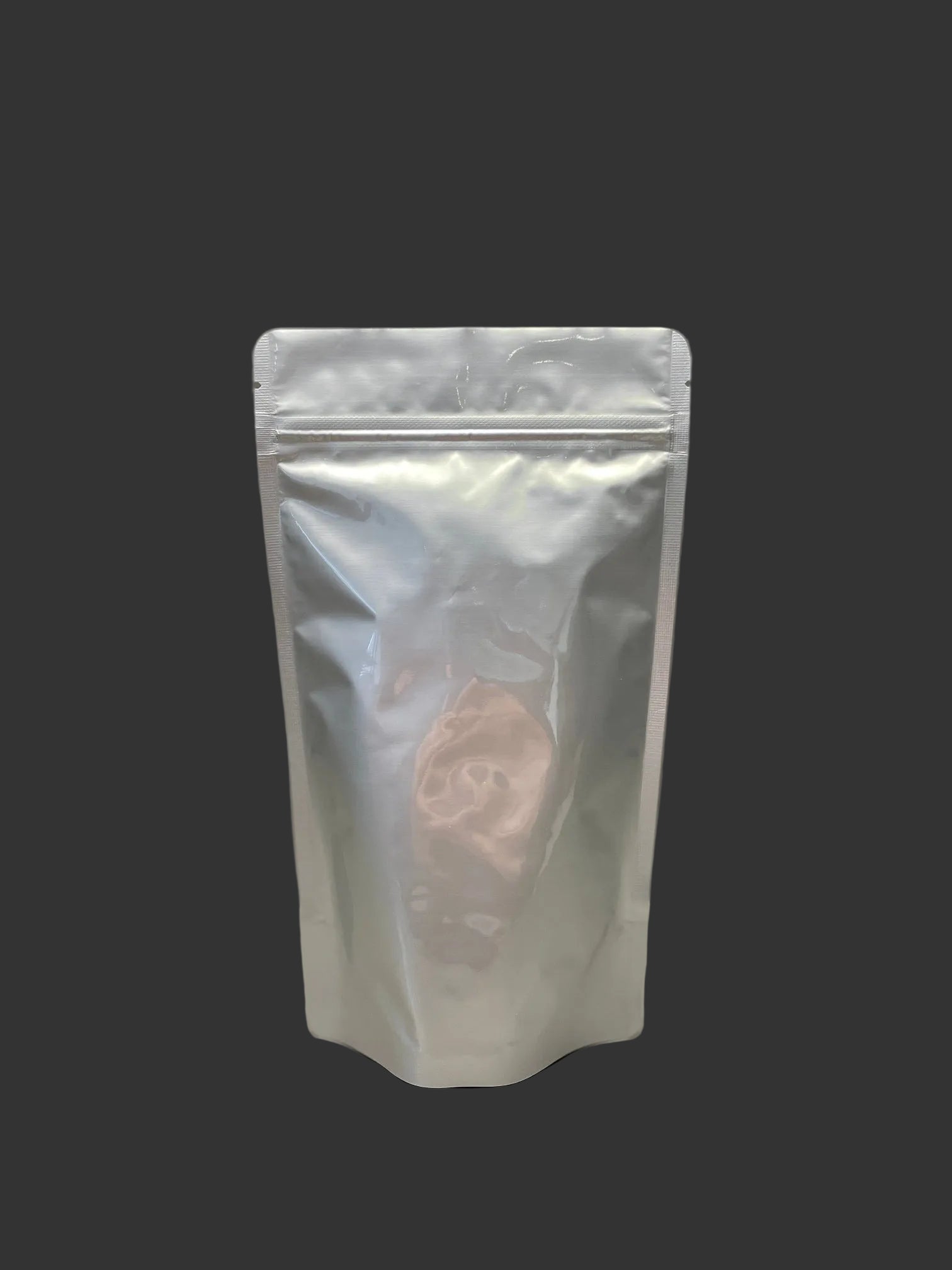 Silver stand-up pouch on a gray background